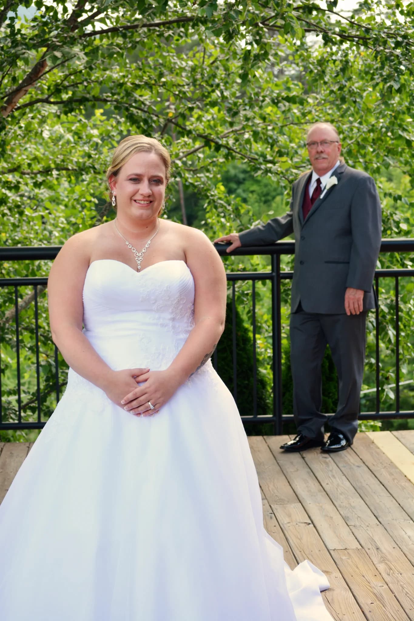 Bride and groom on deck with forest views near Smoky Mountains at Moose Hollow Lodge in Pigeon Forge near Dollywood