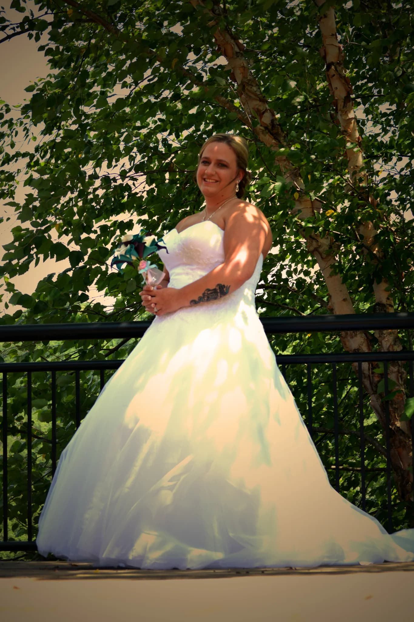Bride in white gown on outdoor deck with forest view near Smoky Mountains at Moose Hollow Lodge in Pigeon Forge