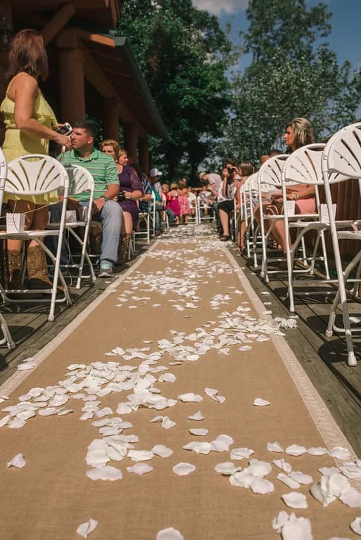 Outdoor wedding aisle with rose petals on a deck at Moose Hollow Lodge in Pigeon Forge near the Smoky Mountains.