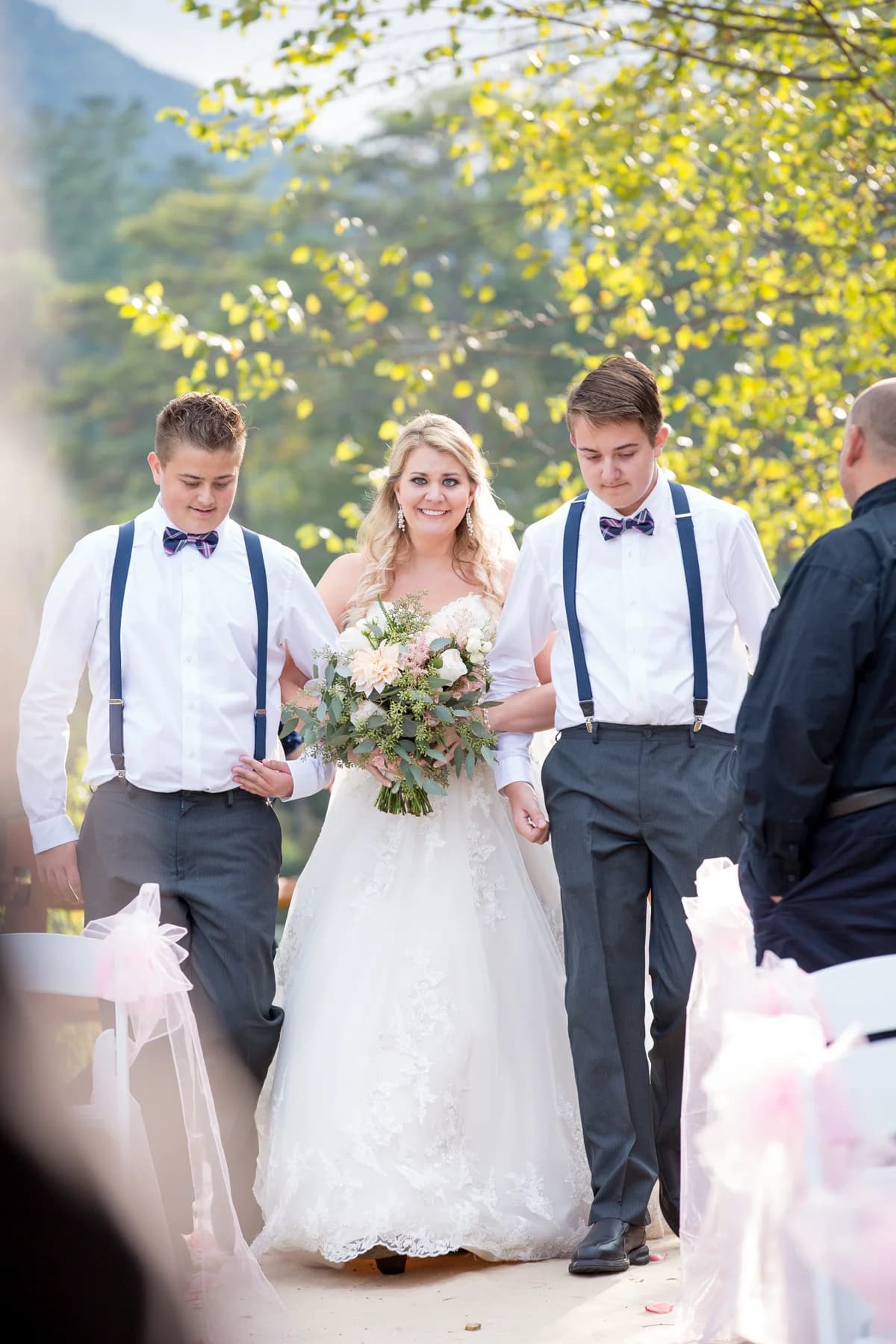 Bride walking down the aisle for an outdoor ceremony at Moose Hollow Lodge in Pigeon Forge near Smoky Mountains