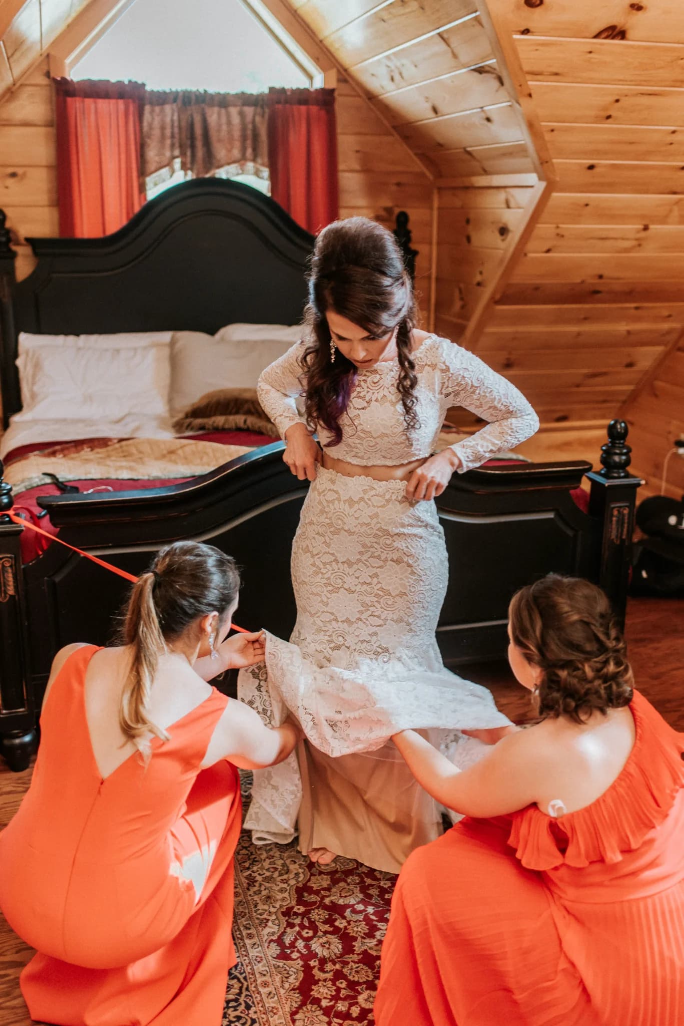 Rustic bedroom with log walls and black bed for bridal prep at Moose Hollow Lodge in Pigeon Forge.
