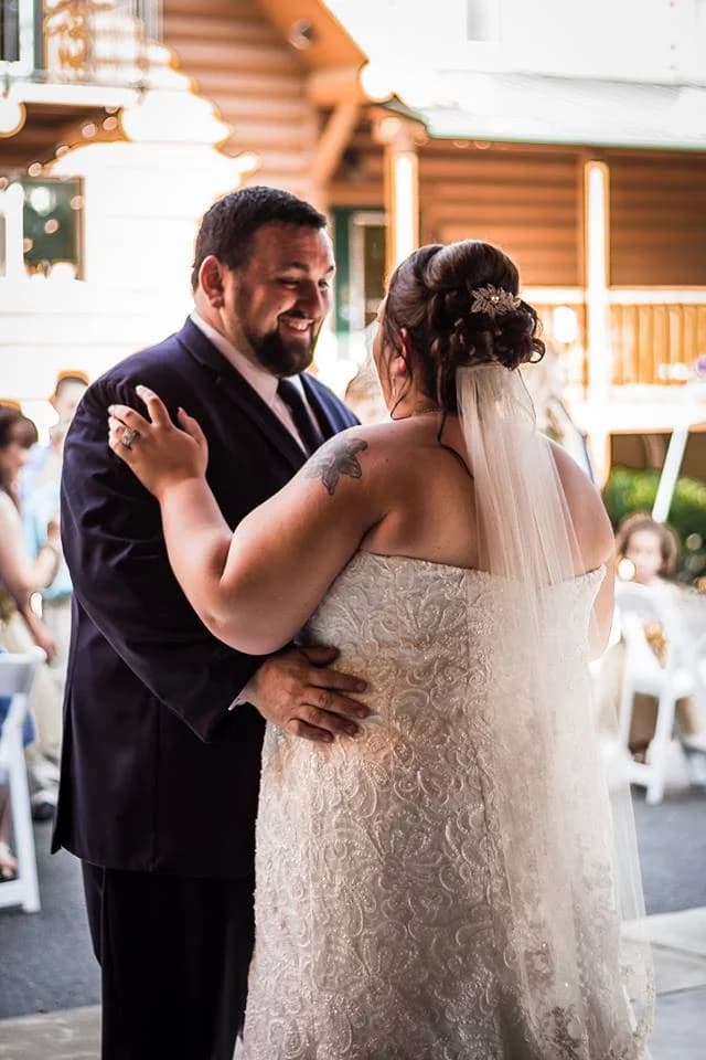 Wedding couple first dance outside log cabin at Moose Hollow Lodge in Pigeon Forge near Dollywood and Smoky Mountains