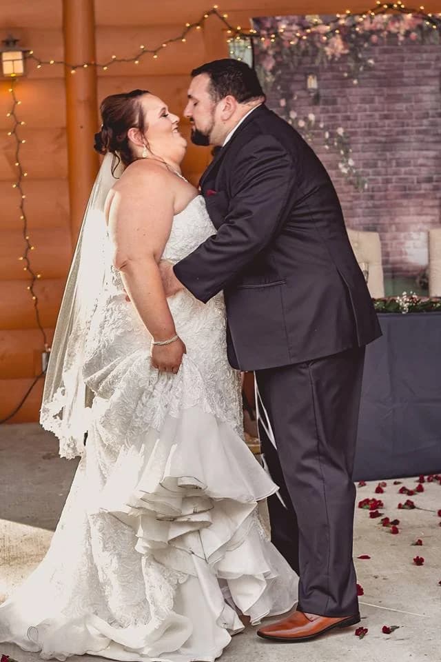 Bride and groom kiss on the rustic wedding deck at Moose Hollow Lodge in Pigeon Forge near Smoky Mountains