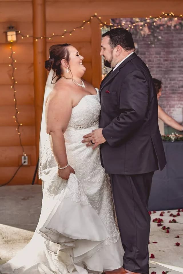 Newlyweds dancing in a rustic log wedding venue with string lights at Moose Hollow Lodge in Pigeon Forge
