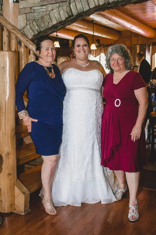 Bride posing by a rustic log staircase inside the wedding venue at Moose Hollow Lodge in Pigeon Forge.