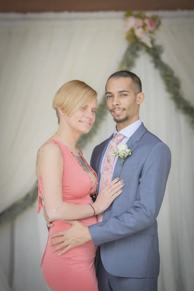 Newlyweds posing in front of white wedding drapery at Moose Hollow Lodge in Pigeon Forge