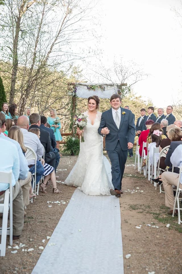 Outdoor wedding ceremony with floral arbor and seating near Smoky Mountains at Moose Hollow Lodge in Pigeon Forge
