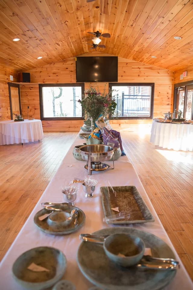 Rustic wood-paneled wedding reception hall with buffet catering at Moose Hollow Lodge in Pigeon Forge