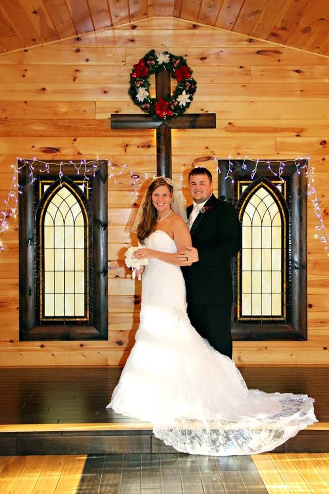 Bride and groom at a rustic wood-paneled wedding chapel altar at Moose Hollow Lodge in Pigeon Forge