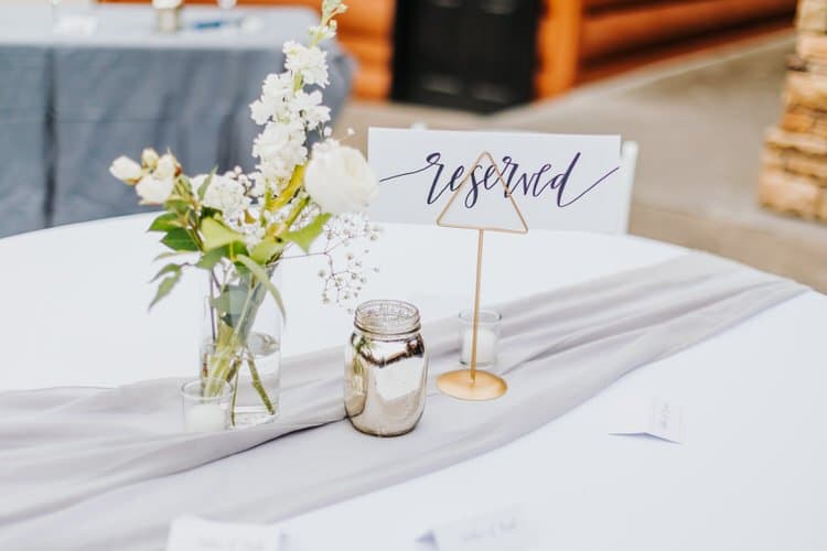 Reserved table with white flowers, mercury glass, candles, gray runner at Moose Hollow Lodge, Sevierville.